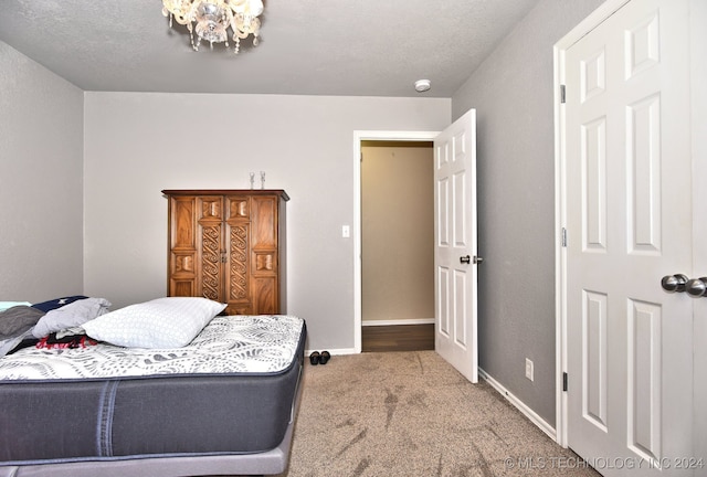 bedroom with carpet floors and a textured ceiling