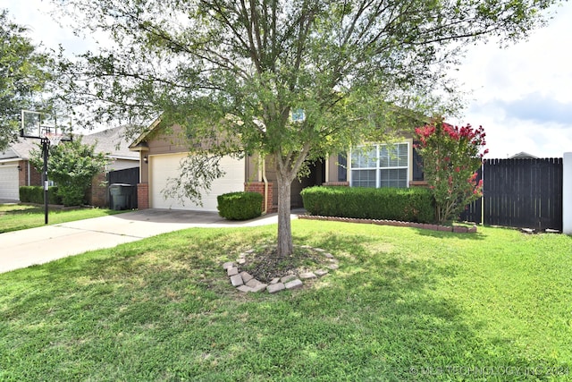 view of property hidden behind natural elements with a garage and a front lawn