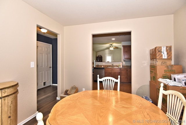 dining area featuring dark hardwood / wood-style floors, ceiling fan, sink, and vaulted ceiling