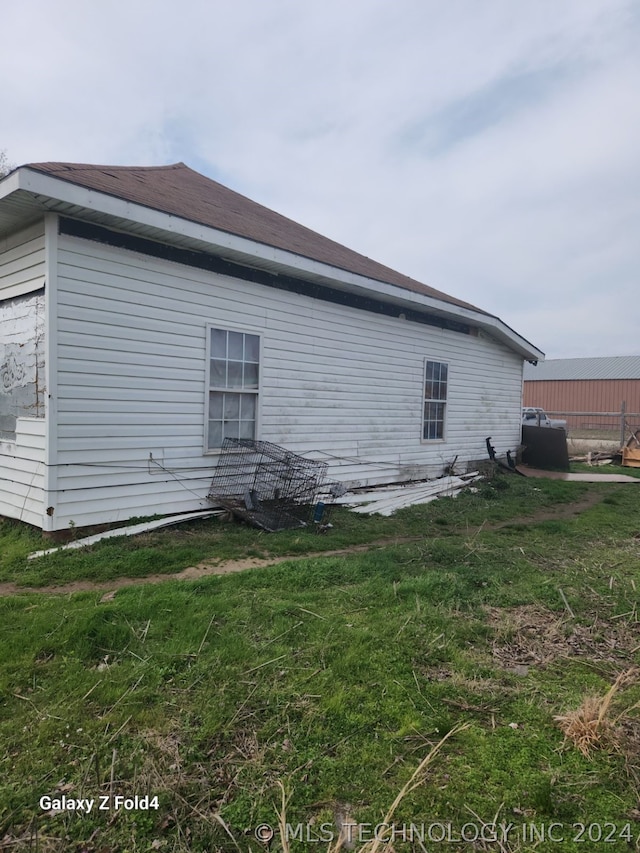 view of side of home featuring a yard