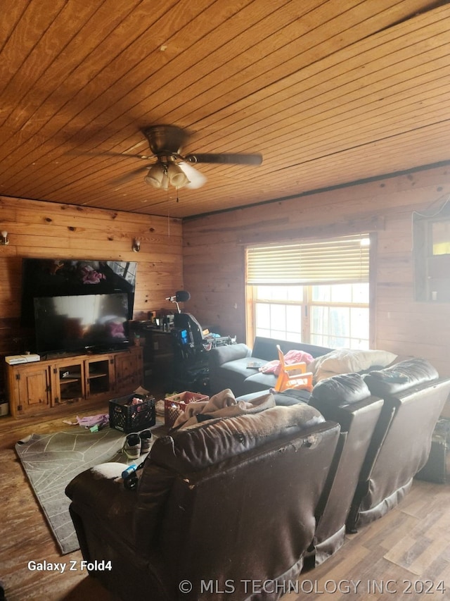 living room featuring wooden walls, ceiling fan, wood ceiling, and hardwood / wood-style flooring