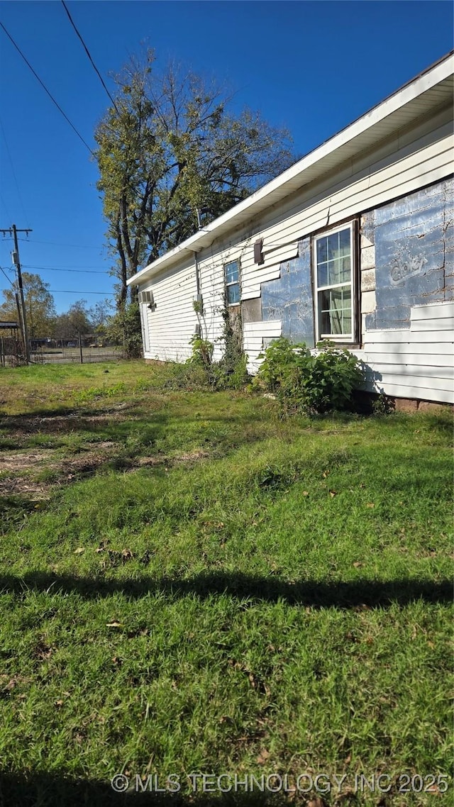 view of side of property with a yard