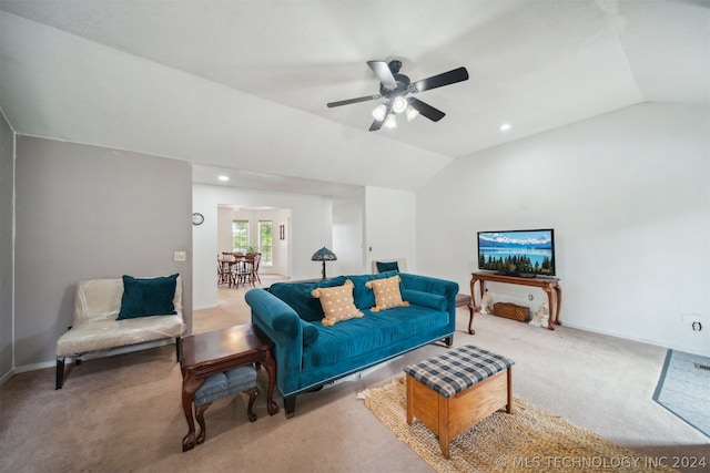 carpeted living room with vaulted ceiling and ceiling fan