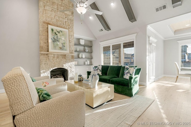 living area featuring high vaulted ceiling, visible vents, baseboards, and wood finished floors