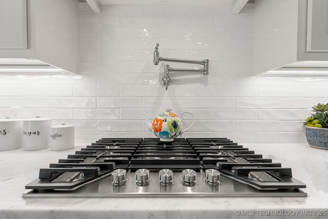 room details with stainless steel gas cooktop and backsplash