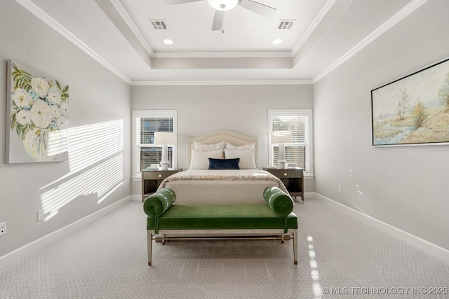 bedroom featuring carpet floors, a tray ceiling, and visible vents