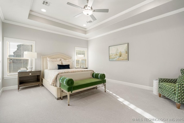 bedroom with light carpet, visible vents, baseboards, ornamental molding, and a tray ceiling