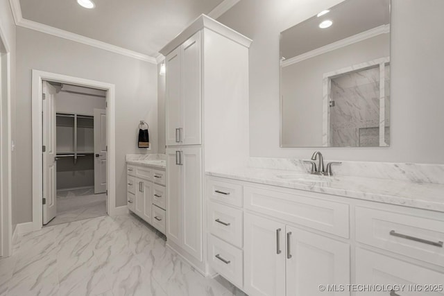 full bath with a walk in closet, marble finish floor, recessed lighting, ornamental molding, and vanity