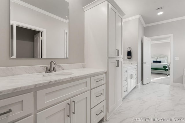 ensuite bathroom with marble finish floor, visible vents, ornamental molding, vanity, and ensuite bath