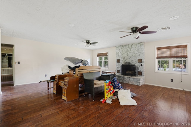 living room featuring a fireplace, hardwood / wood-style floors, and a wealth of natural light