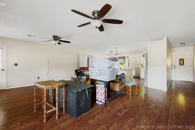 living room with dark hardwood / wood-style floors, a textured ceiling, and ceiling fan