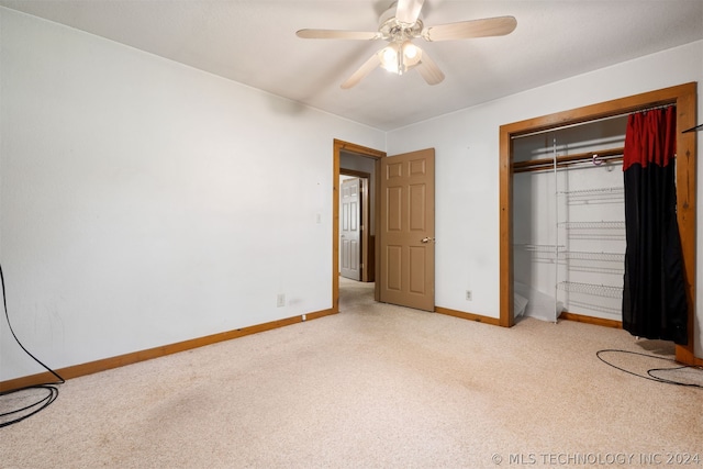 unfurnished bedroom with carpet, a closet, and ceiling fan