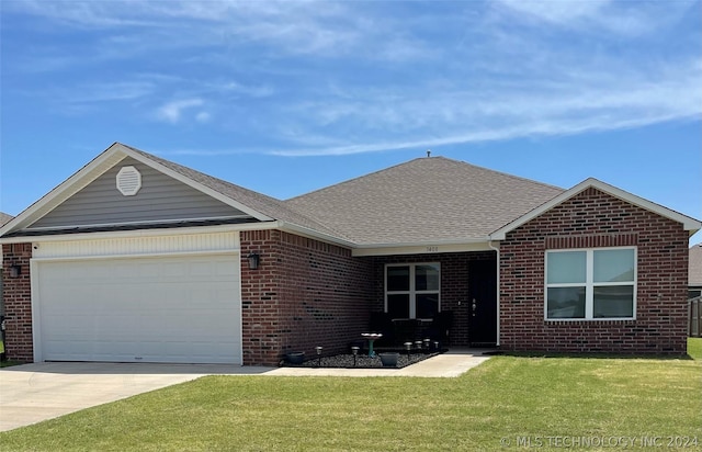 single story home with a garage and a front lawn