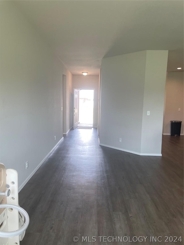 empty room with dark wood-type flooring