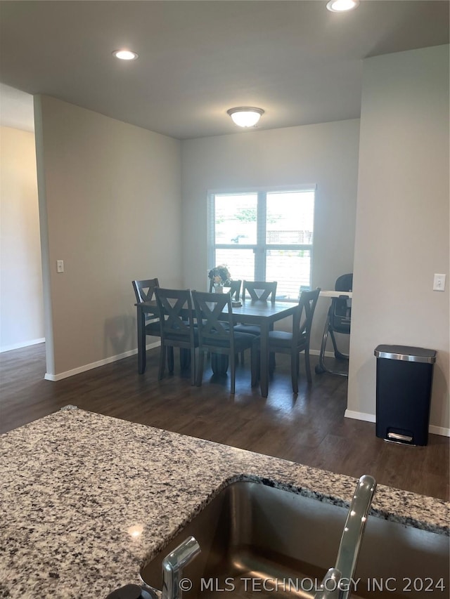 dining space with dark hardwood / wood-style flooring