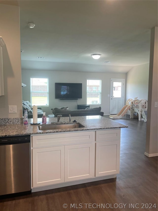 kitchen with sink, stainless steel dishwasher, white cabinets, and light stone countertops