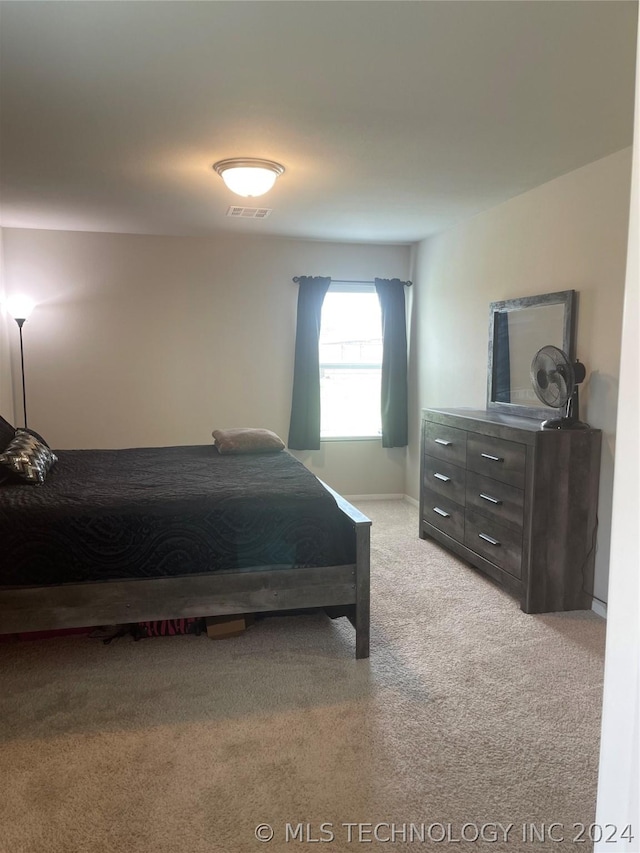 bedroom featuring light colored carpet