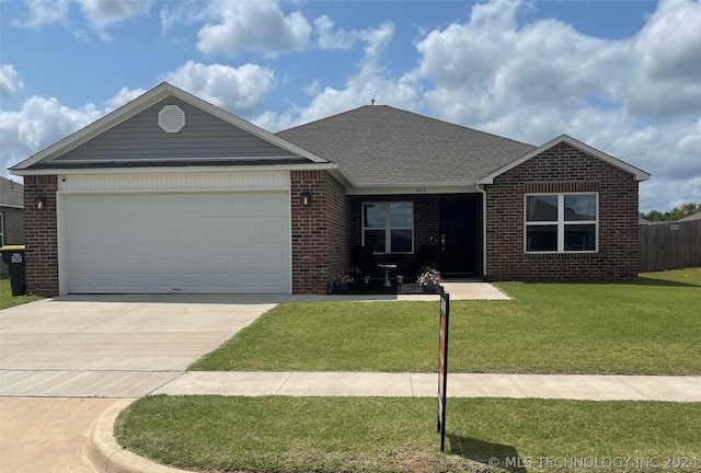 single story home with a garage and a front lawn