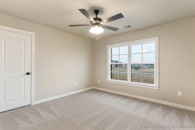 carpeted empty room featuring ceiling fan