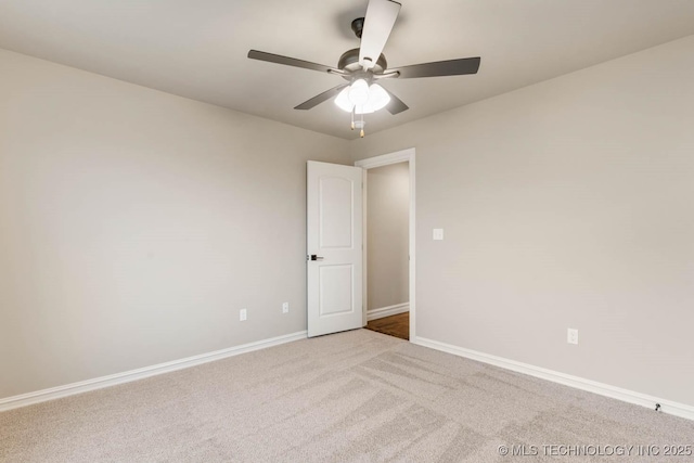 empty room featuring ceiling fan and light carpet