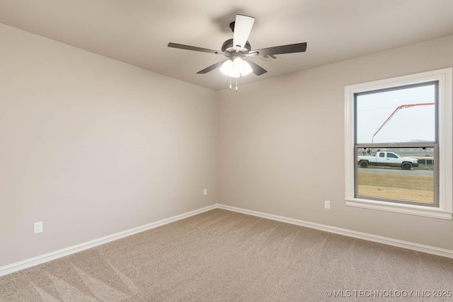 empty room featuring ceiling fan and carpet