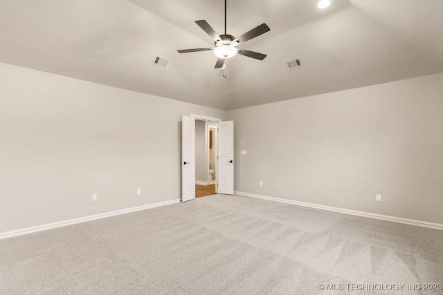 carpeted empty room featuring vaulted ceiling and ceiling fan