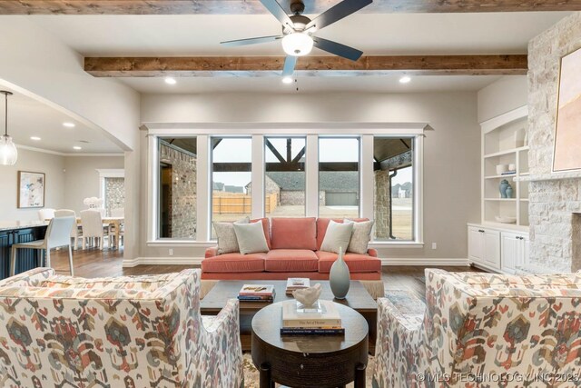 living room featuring wood-type flooring, ceiling fan, built in features, and beam ceiling