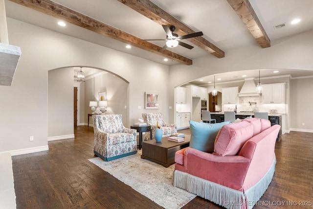 living room with dark wood-type flooring, beamed ceiling, and ceiling fan