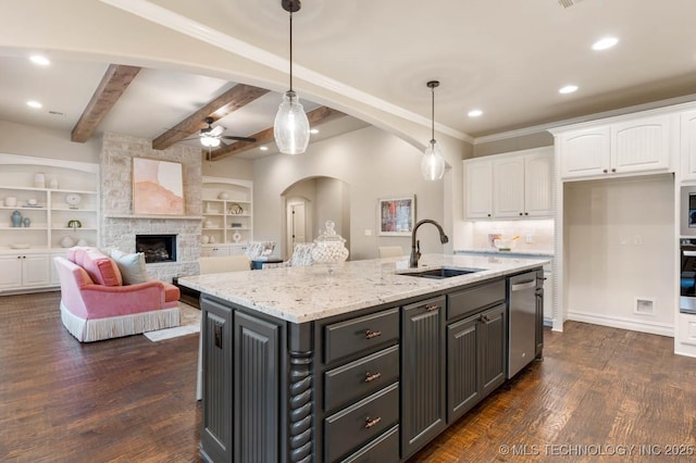 kitchen featuring white cabinetry, sink, hanging light fixtures, stainless steel appliances, and light stone countertops