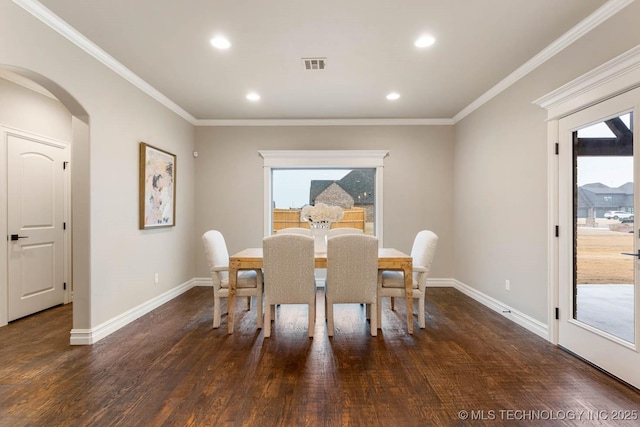 dining area featuring crown molding and dark hardwood / wood-style flooring