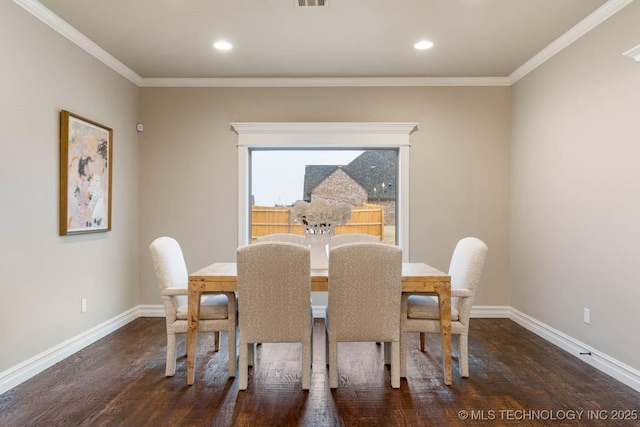 dining space featuring crown molding and dark wood-type flooring