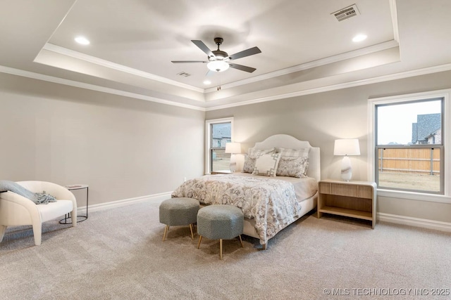 bedroom with crown molding, ceiling fan, a raised ceiling, and carpet