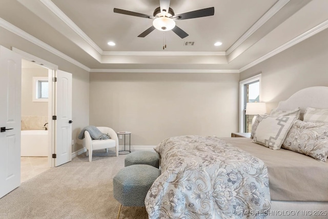 carpeted bedroom featuring crown molding, a raised ceiling, and multiple windows