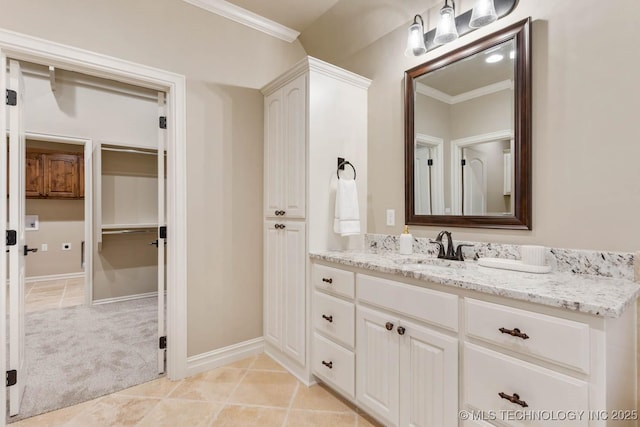 bathroom with ornamental molding, tile patterned flooring, and vanity