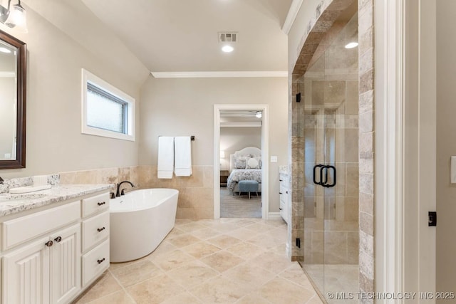 bathroom featuring vanity, ornamental molding, plus walk in shower, and tile walls