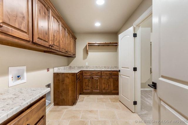 laundry area featuring hookup for a washing machine and cabinets