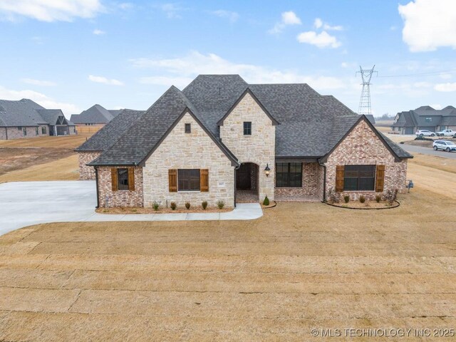 french provincial home featuring a front yard