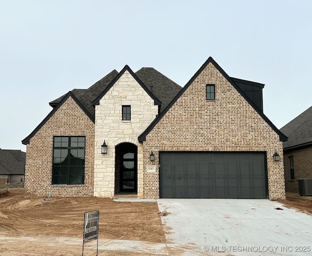 view of front of property with cooling unit and a garage