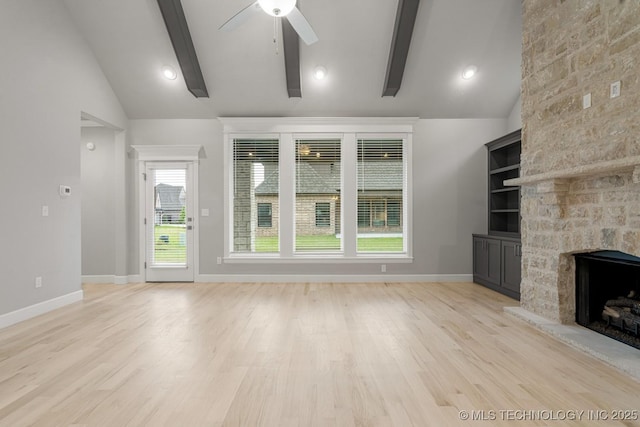 unfurnished living room featuring ceiling fan, a stone fireplace, light wood finished floors, and baseboards