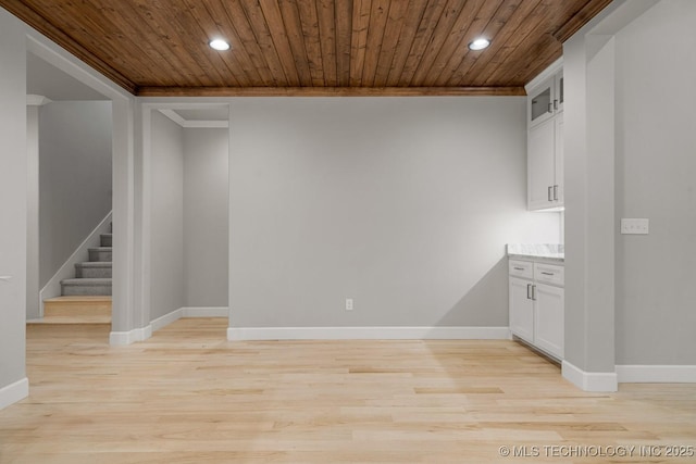 spare room with wooden ceiling, recessed lighting, crown molding, light wood-type flooring, and baseboards