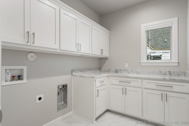 clothes washing area featuring cabinet space, hookup for a washing machine, light marble finish flooring, electric dryer hookup, and baseboards
