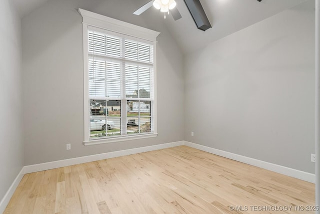 unfurnished room with lofted ceiling, plenty of natural light, a ceiling fan, and wood finished floors