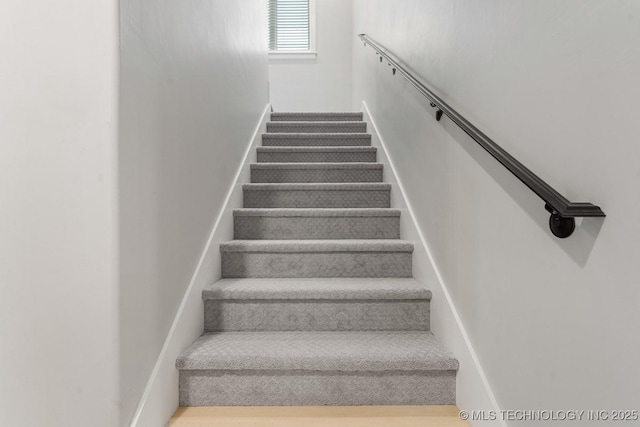 stairs with wood finished floors