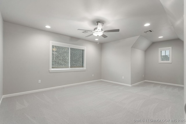 additional living space featuring light carpet, baseboards, a ceiling fan, recessed lighting, and lofted ceiling