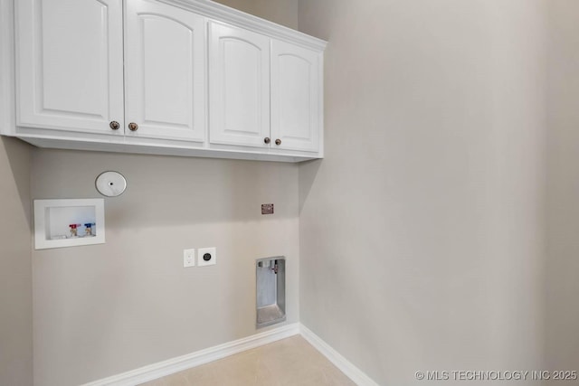 laundry area featuring light tile patterned flooring, washer hookup, hookup for an electric dryer, gas dryer hookup, and cabinets