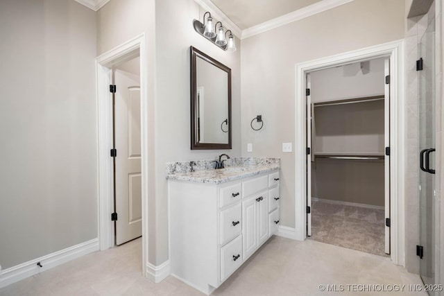 bathroom featuring crown molding, a shower with shower door, and vanity