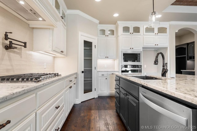 kitchen with decorative backsplash, sink, white cabinetry, and stainless steel appliances