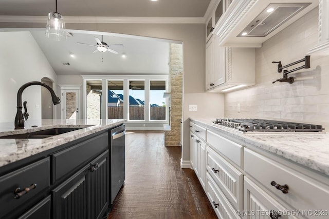 kitchen with stainless steel appliances, dark wood-type flooring, pendant lighting, white cabinets, and sink