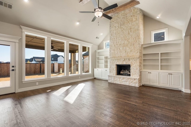 unfurnished living room featuring ceiling fan, a stone fireplace, high vaulted ceiling, built in shelves, and dark hardwood / wood-style flooring