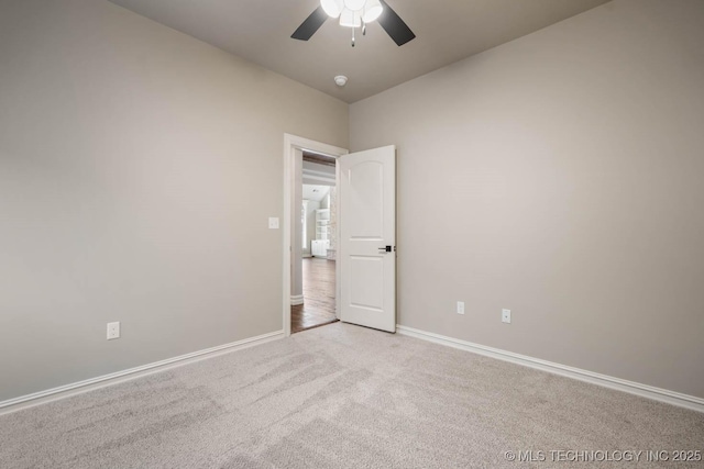 unfurnished room with ceiling fan and light colored carpet